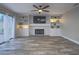 Bright living room with fireplace, built-in shelving, and sliding glass doors to the backyard at 5452 Big Sky Ln, Las Vegas, NV 89149