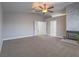Comfortable living room features neutral colors, a ceiling fan, and access to ensuite bathroom at 5452 Big Sky Ln, Las Vegas, NV 89149