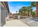 A view of the balcony with metal railing and palm trees at 5785 Farmhouse Ct, Las Vegas, NV 89141
