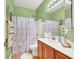 Cozy bathroom with a shower-tub combo, a vanity, and a floral shower curtain at 5785 Farmhouse Ct, Las Vegas, NV 89141