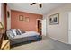 Bedroom with a bed, artwork, and an open door leading to another room at 5785 Farmhouse Ct, Las Vegas, NV 89141
