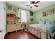 Charming bedroom with a decorative bed frame, built-in desk, and wood flooring at 5785 Farmhouse Ct, Las Vegas, NV 89141