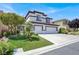 Charming two-story home with a three-car garage and a well-maintained front yard at 5785 Farmhouse Ct, Las Vegas, NV 89141