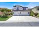 Two-story home featuring a three-car garage, stucco exterior, and a well-manicured lawn at 5785 Farmhouse Ct, Las Vegas, NV 89141