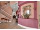 Entryway with a view of staircase, decorative mirror and console table, and tile flooring at 5785 Farmhouse Ct, Las Vegas, NV 89141