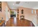 Hallway with hardwood floors leading to an archway opening into a living area at 5785 Farmhouse Ct, Las Vegas, NV 89141
