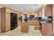 Well-equipped kitchen with stainless steel appliances, a central island and tile flooring at 5785 Farmhouse Ct, Las Vegas, NV 89141