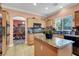 Gourmet kitchen with granite counters and an island, flowing into dining area at 5785 Farmhouse Ct, Las Vegas, NV 89141