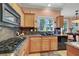 The kitchen features granite counters, stainless appliances, and adjacent breakfast nook at 5785 Farmhouse Ct, Las Vegas, NV 89141