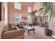 Spacious living room featuring tall ceilings, large windows, and views into the adjacent dining area at 5785 Farmhouse Ct, Las Vegas, NV 89141