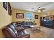 Spacious living room featuring a large sectional sofa and a ceiling fan at 5785 Farmhouse Ct, Las Vegas, NV 89141