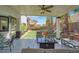 Inviting covered patio with comfortable seating and a view of the manicured lawn at 5785 Farmhouse Ct, Las Vegas, NV 89141