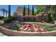 Welcoming community entrance sign with decorative stone accents and colorful flower beds at 5785 Farmhouse Ct, Las Vegas, NV 89141