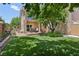 Landscaped backyard features a patio, mature tree, and lush lawn at 639 I Ave, Boulder City, NV 89005