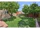 A well-maintained backyard with lush lawn, mature trees, and brick edging, providing a serene outdoor space at 639 I Ave, Boulder City, NV 89005