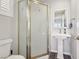 Compact bathroom features a stand-up shower with decorative door and a pedestal sink at 639 I Ave, Boulder City, NV 89005
