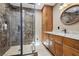 Updated bathroom featuring a glass enclosed shower, stone floors, and a modern vanity and lighting at 639 I Ave, Boulder City, NV 89005