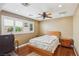 Cozy bedroom with a ceiling fan, natural light, and wood floors; perfect for relaxation and rest at 639 I Ave, Boulder City, NV 89005
