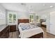 Comfortable bedroom with hardwood floors, ceiling fan, two windows, and closet with sliding doors at 639 I Ave, Boulder City, NV 89005