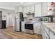 Updated kitchen boasts stainless steel appliances, white cabinets, and stone countertops at 639 I Ave, Boulder City, NV 89005