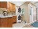 Convenient laundry room boasts ample cabinetry, countertop space, a sink, and stacked washer/dryer at 639 I Ave, Boulder City, NV 89005