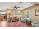 Comfortable living room with hardwood floors, ceiling fan, and large windows offering natural light at 639 I Ave, Boulder City, NV 89005