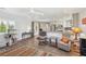 Living room showcasing a ceiling fan, stylish chairs, hardwood floors, cat tree and a partial view of the kitchen at 639 I Ave, Boulder City, NV 89005