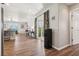 Living room view with ceiling fan, sliding glass doors, hardwood floors, and a glimpse into the kitchen at 639 I Ave, Boulder City, NV 89005