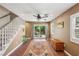 Bright living room featuring a staircase, sliding glass door, hardwood flooring, and backyard views at 639 I Ave, Boulder City, NV 89005