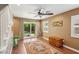 Bright living area with a ceiling fan, rug, sliding glass doors and a view to the backyard at 639 I Ave, Boulder City, NV 89005