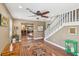 Spacious living room with hardwood floors, a ceiling fan, and staircase leading to upper level at 639 I Ave, Boulder City, NV 89005
