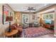 Cozy living room boasts hardwood floors, ceiling fan, ample natural light, and stylish decor at 639 I Ave, Boulder City, NV 89005