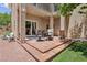 Inviting outdoor patio with brick flooring, covered seating area, and views of the landscaped backyard at 639 I Ave, Boulder City, NV 89005
