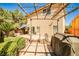 Backyard featuring a brick patio, a grill, a decorative bridge, a pergola, and a covered seating area at 6409 Shawnee Springs Ct, Las Vegas, NV 89139