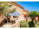 Backyard featuring a brick patio, outdoor seating, a grill, a decorative bridge, and landscaping at 6409 Shawnee Springs Ct, Las Vegas, NV 89139
