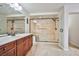 Elegant bathroom with double sinks, granite countertop, and a large glass-enclosed shower at 6409 Shawnee Springs Ct, Las Vegas, NV 89139