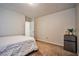 Bedroom featuring a white bed, neutral walls, a mini-fridge, carpet, and a door at 6409 Shawnee Springs Ct, Las Vegas, NV 89139