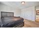 Bedroom featuring a neutral carpet, a wooden bed frame, a double door closet, and a light on the ceiling at 6409 Shawnee Springs Ct, Las Vegas, NV 89139