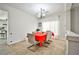 Bright dining room featuring tile floors, a modern chandelier, and an elegant dining table with seating for six at 6409 Shawnee Springs Ct, Las Vegas, NV 89139
