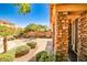 This home features an inviting front exterior with manicured shrubs and a paved driveway leading to the main entrance at 6409 Shawnee Springs Ct, Las Vegas, NV 89139