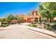 Beautifully landscaped two-story home showcasing lush greenery and a brick driveway, enhancing its curb appeal at 6409 Shawnee Springs Ct, Las Vegas, NV 89139