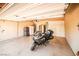 Spacious garage with epoxy floors, storage cabinets, stainless steel refrigerator, and motorcycle at 6409 Shawnee Springs Ct, Las Vegas, NV 89139