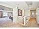 Hallway leading to a bedroom, carpeted with a painting on the wall and a glass railing at 6409 Shawnee Springs Ct, Las Vegas, NV 89139