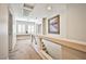 Bright upstairs hallway with carpeted floors, lots of natural light, and glass railing at 6409 Shawnee Springs Ct, Las Vegas, NV 89139