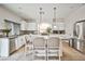 Spacious kitchen with white cabinetry, granite countertops, stainless steel appliances, and large central island with seating at 6409 Shawnee Springs Ct, Las Vegas, NV 89139