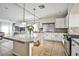 Open-concept kitchen features a large island, granite countertops, modern appliances, and seamless transition to the living area at 6409 Shawnee Springs Ct, Las Vegas, NV 89139