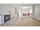 Expansive living area featuring an open floor plan, tile flooring, a fireplace, and seamless transition to the dining space at 6409 Shawnee Springs Ct, Las Vegas, NV 89139