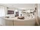 Bright open concept living room and kitchen with tile floors and large gray sectional at 6409 Shawnee Springs Ct, Las Vegas, NV 89139