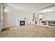 Spacious living room featuring tile floors, a fireplace, and an open layout that flows seamlessly into the dining area at 6409 Shawnee Springs Ct, Las Vegas, NV 89139
