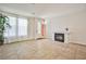 The living room boasts tile floors, neutral walls, a fireplace, and large windows that let in plenty of natural light at 6409 Shawnee Springs Ct, Las Vegas, NV 89139